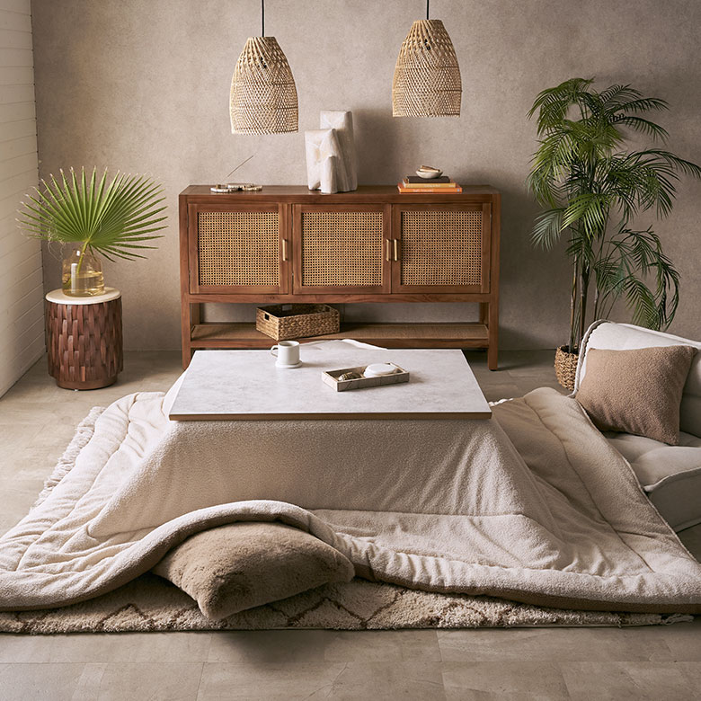 アジアンリゾート風の部屋にクッションカバーとこたつ布団をコーディネートした写真